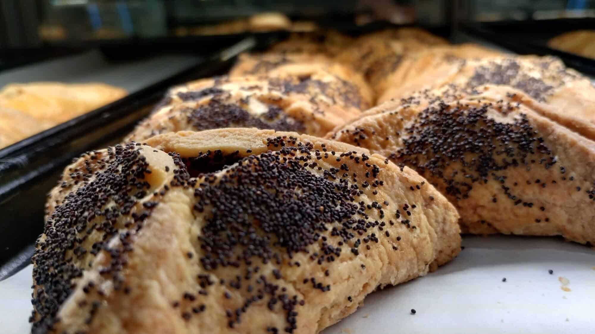 Poppy-seed hamantashen at Famous 4th Street Deli in Philadelphia, established in 1923. General manager Lou Novak says the dairy version is made with “lots of butter,” sprinkled with poppy seeds on the top and sides using even more butter, March 2, 2025. Photo by Carin M. Smilk.