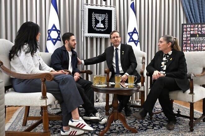 Released Hamas hostage Omer Shem Tov and his mother, Shelly, with Israeli President Isaac Herzog and his wife, Michal, at the President's Residence in Jerusalem, March 24, 2025. Photo by Avi Kaner/GPO.