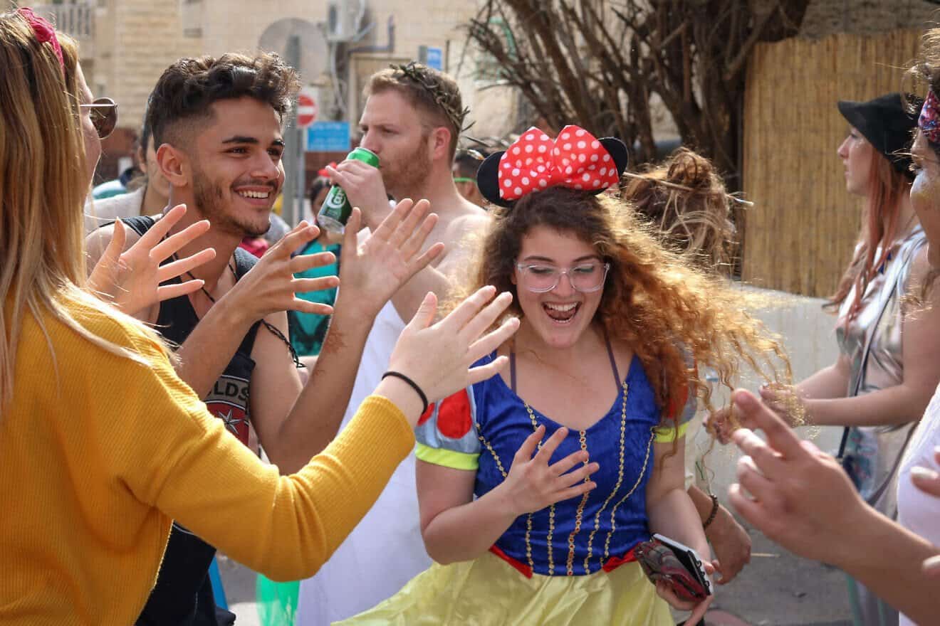 People dancing at a street party in the Nachlaot neighborhood of Jerusalem during Purim on March 1, 2018. Photo by Liba Farkash/Flash90.
