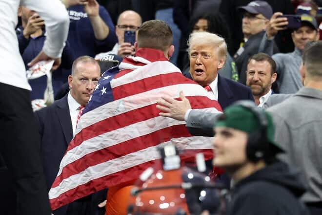 U.S. President Donald Trump congratulates Wyatt Hendrickson of the Oklahoma State Cowboys after winning the 285 pound (129 kg.) championship match at the 2025 NCAA Division I Wrestling Championships in Philadelphia on March 22, 2025. Photo by Hunter Martin/Getty Images.