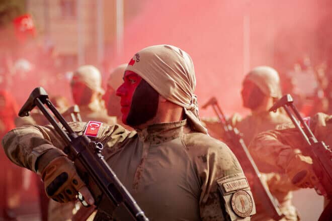 Turkish soldiers stand at attention as red smoke fills the air during Republic Day celebrations in Kayseri on Oct. 29, 2024. Photo by Damoun Pournemati/Middle East Images via AFP.