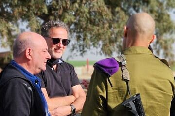 Eshkol Regional Council security chief Ilan Isaacson and Ari Briggs in the field with an IDF officer. 