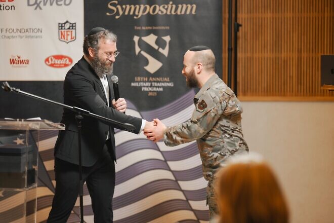 Rabbi Chanania Steinmetz (right), a U.S. Air Force chaplain, shakes hands with Rabbi Aaron Lipskar, CEO of the Aleph Institute, at the 18th Annual Aleph Military Symposium in Surfside, Fla., March 6, 2025. Credit: Yisroel Teitelbaum/Aleph Institute.