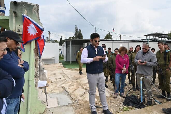 Pravesh Jiral commemorates his murdered countrymen in Kibbutz Alumim, Israel on Feb. 13, 2025. Photo by Canaan Lidor.