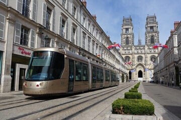 A tram travels down  Jeanne-d'Arc Street in Orléans, France, on June 24, 2018. Credit: Bmazerolles via Wikimedia Commons.