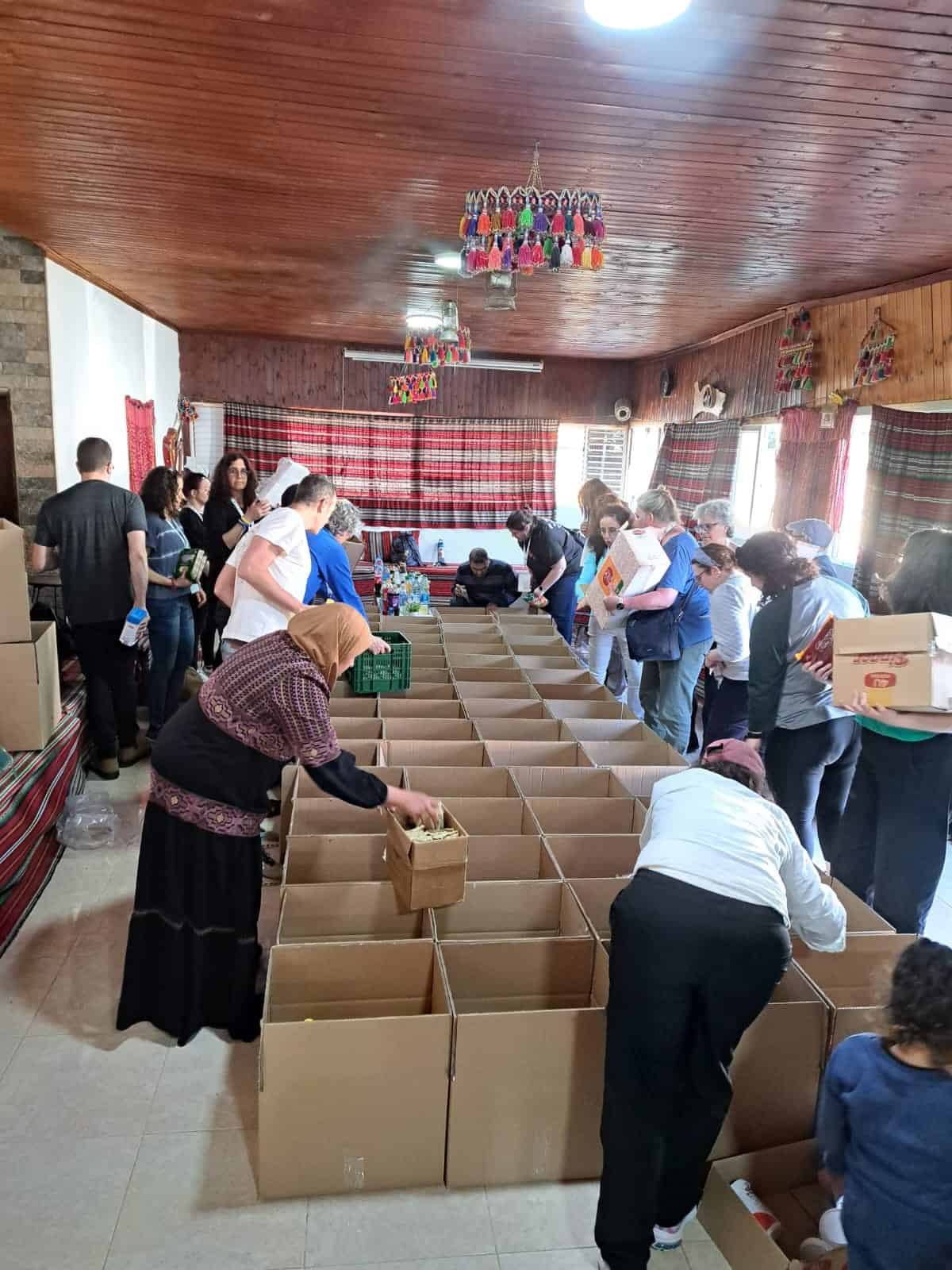 Volunteers distribute supplies to the Bedouin community