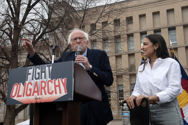 Sen. Bernie Sanders, (I-Vt.) and Rep. Alexandria Ocasio Cortez (D-N.Y.) speak to supporters during the “Fighting Oligarchy: Where We Go From Here” rally at Civic Center Park in Denver on March 21, 2025. Photo by Jason Connolly/AFP via Getty Images.