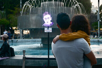 Hologram images of Holocaust survivors are displayed on the Dizengoff Square fountain in Tel Aviv, ahead of Yom Hashoah, Holocaust Remembrance Day, April 16, 2023. Credit: Avshalom Sassoni/Flash90.