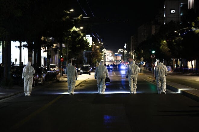 Members of the Greek police's counter-terrorism unit investigate the area outside the Hellenic Train offices in central Athens after a bombing, April 11, 2025. Photo by Aris OIkonomou/SOOC/AFP via Getty Images.