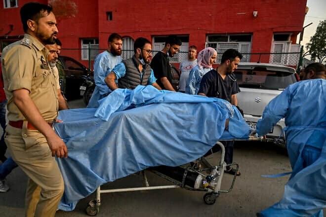 Paramedics and police personnel carry an injured tourist at a hospital in Anantnag, south of Srinagar, on April 22, 2025, following an attack. Gunmen in Indian-administered Kashmir opened fire on a group of tourists on April 22, with the chief minister saying the "inhuman" attack was one of the worst targeting civilians for years. At least five people were killed, a senior politician in the Himalayan region said. Photo by Tauseef Mustafa/AFP via Getty Images.