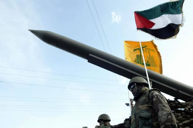 Hezbollah terrorists parade with a missile as the Palestinian (R) and the movement's (back) flags flutter during an annual parade in the southern city of Nabatiyeh on Jan. 10, 2009. Photo Mahmoud Zayat/AFP via Getty Images.