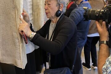 Suzana Leibowitz reviews the Book of Names at Auschwitz, April 23, 2025. Photo by Etgar Lefkovits.
