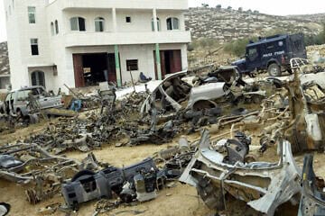 IDF soldiers and military police enter a home in Dhahiriya, southwestern Judea, looking for Palestinians who have stolen Israeli cars, Aug. 3, 2004. Credit: Flash90.