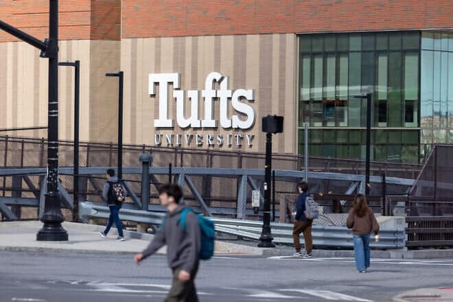 People walk on College Avenue near Tufts University in Medford, Mass., on March 27, 2025. Photo by Scott Eisen/Getty Images.