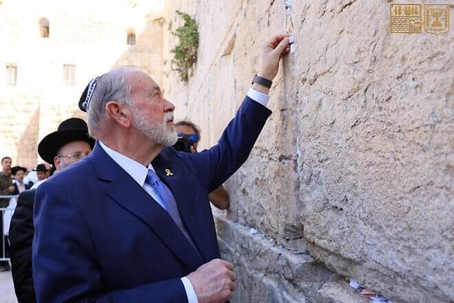 U.S. Ambassador to Israel Mike Huckabee inserts a note from President Donald Trump into a crack in the Western Wall, April 18, 2025. Credit: Western Wall Heritage Foundation.